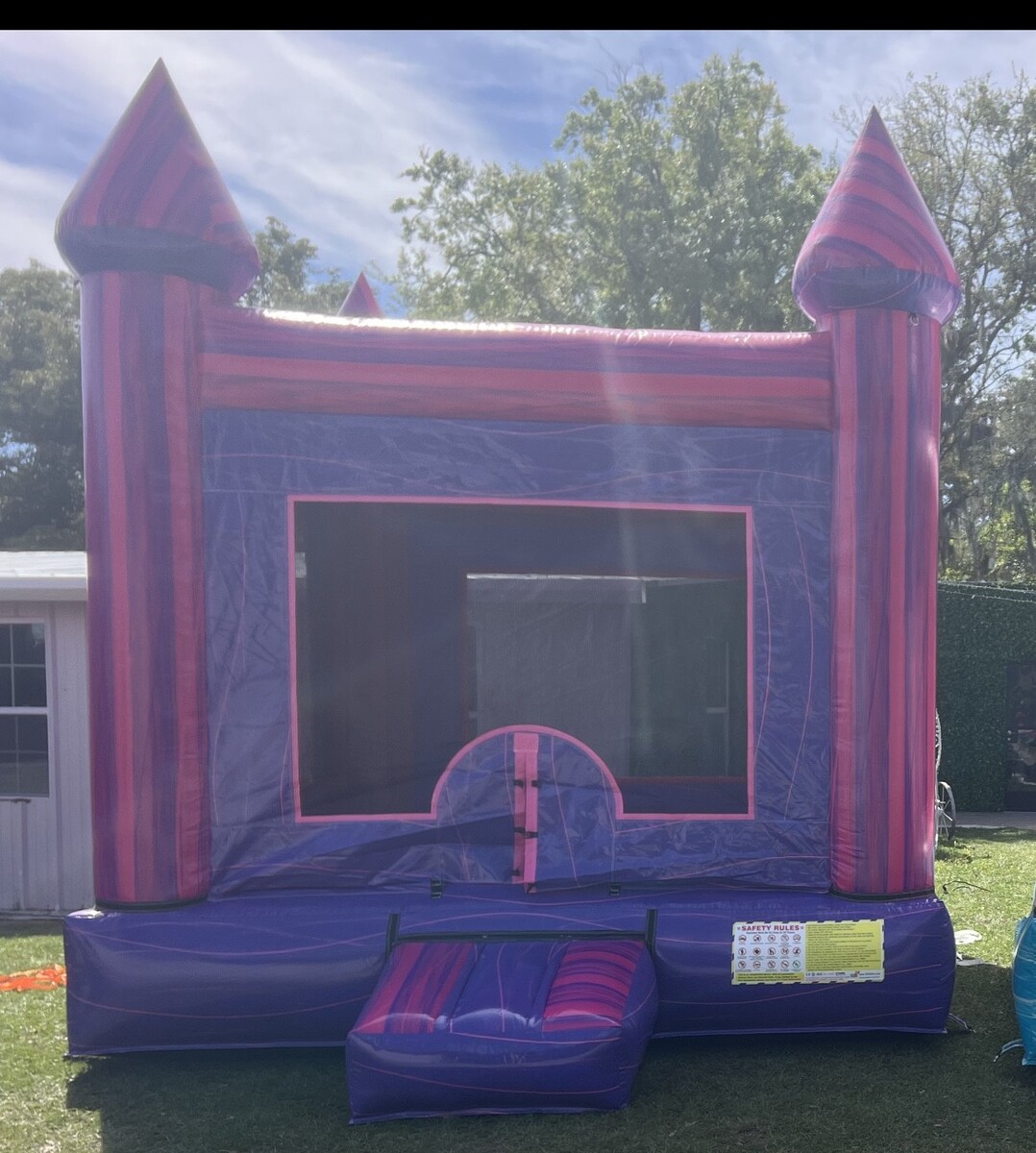 Purple Bounce House in meadow wood